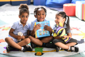 Children reading a story book in a tutoring session