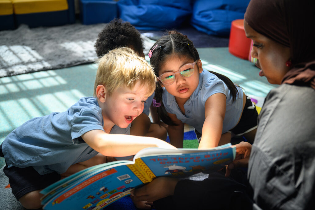 Children pointing to a story book